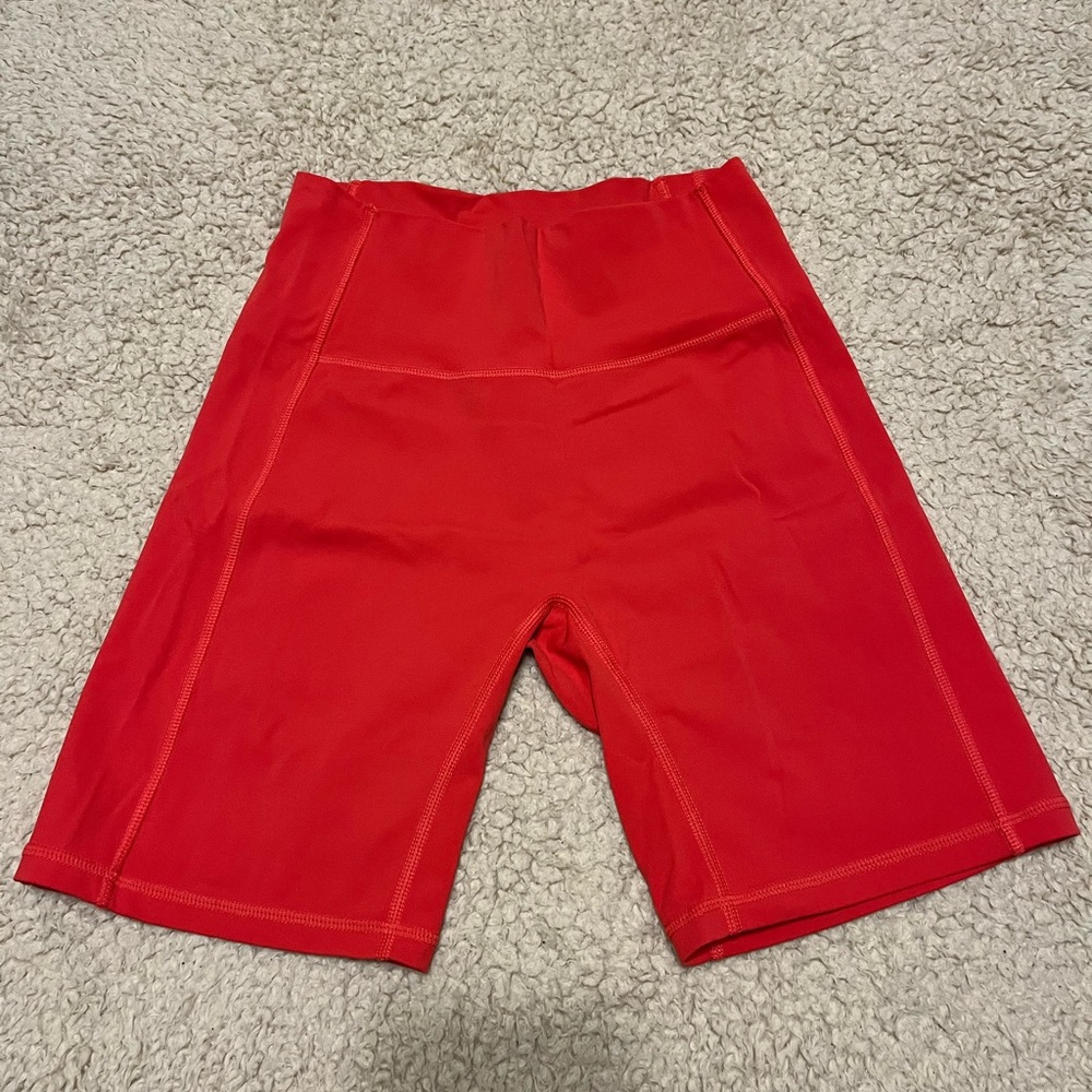 Alphalete pulse biker shorts in coral, size medium